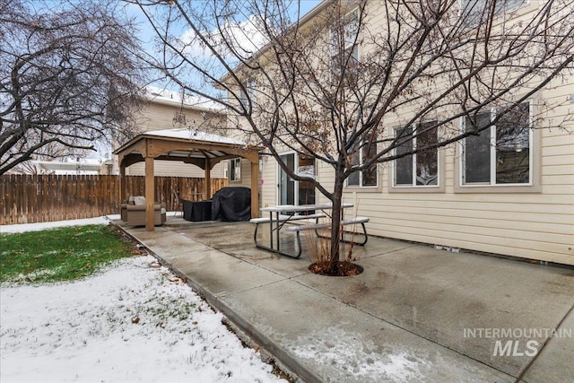 snow covered patio with a gazebo