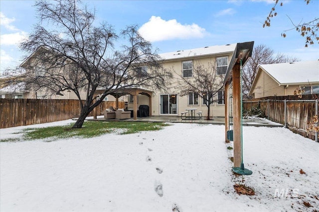 snow covered house featuring an outdoor hangout area