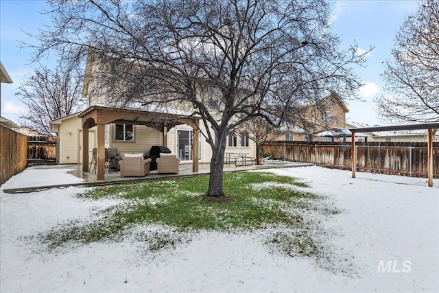 yard covered in snow featuring a patio area and outdoor lounge area