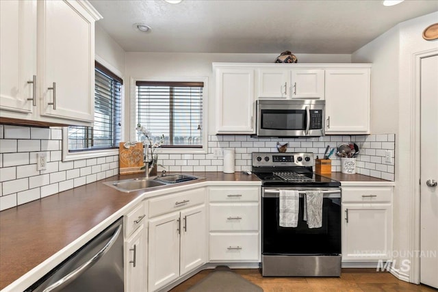 kitchen with white cabinetry, sink, and appliances with stainless steel finishes