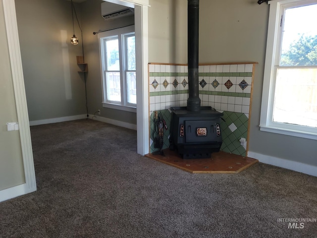 585 N 5th E, Mountain Home, ID 83647 - detailed view of carpet, a wood stove, and an AC wall unit