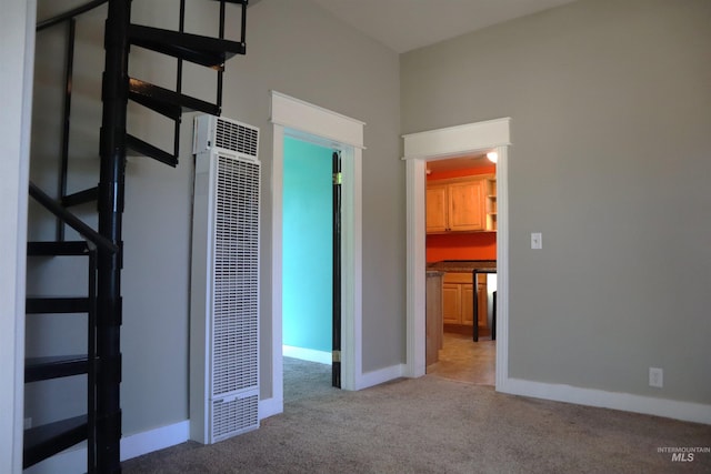 585 N 5th E, Mountain Home, ID 83647 - unfurnished bedroom with a heating unit, light colored carpet, and baseboards
