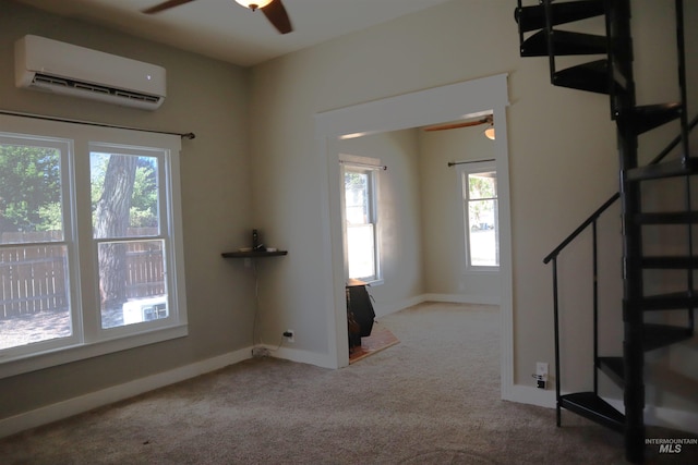 585 N 5th E, Mountain Home, ID 83647 - empty room featuring ceiling fan, a wall mounted air conditioner, carpet floors, and plenty of natural light