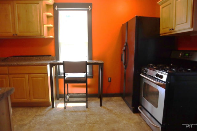 585 N 5th E, Mountain Home, ID 83647 - kitchen featuring stainless steel gas range, open shelves, and dark countertops