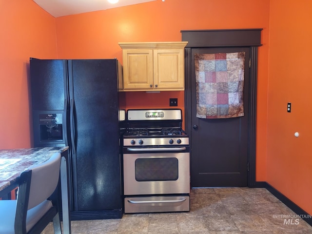 585 N 5th E, Mountain Home, ID 83647 - kitchen with black refrigerator with ice dispenser, stainless steel gas stove, and baseboards