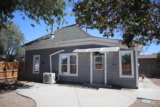 585 N 5th E, Mountain Home, ID 83647 - back of property with a cooling unit, a shingled roof, and a patio
