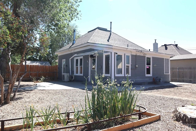 585 N 5th E, Mountain Home, ID 83647 - rear view of property with a fenced backyard, a patio area, a chimney, and a shingled roof
