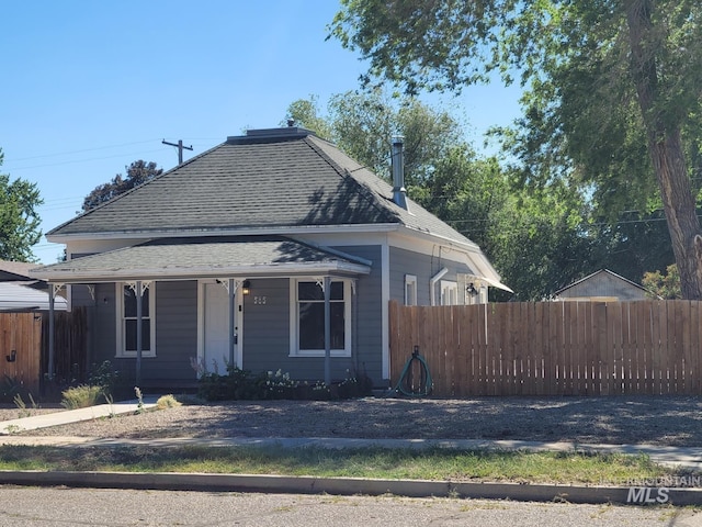 585 N 5th E, Mountain Home, ID 83647 - view of front of house featuring a shingled roof and covered porch