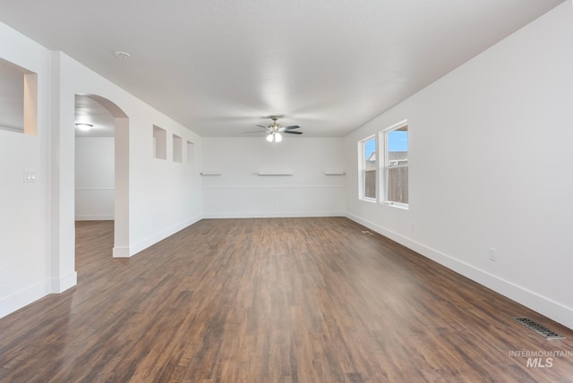 spare room featuring dark hardwood / wood-style flooring and ceiling fan