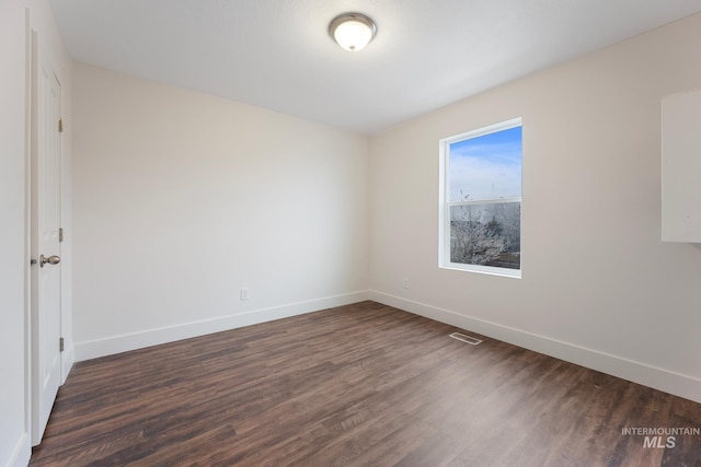 empty room with dark hardwood / wood-style floors