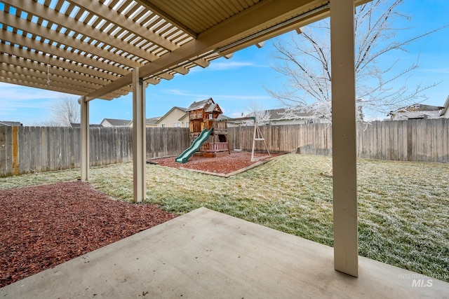 view of yard featuring a pergola, a patio area, and a playground