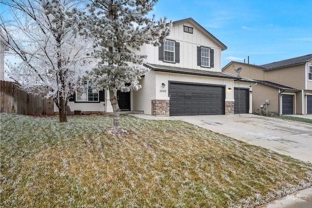 view of front of property featuring a garage and a front lawn