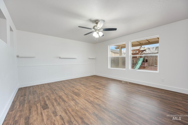 spare room featuring dark hardwood / wood-style floors and ceiling fan