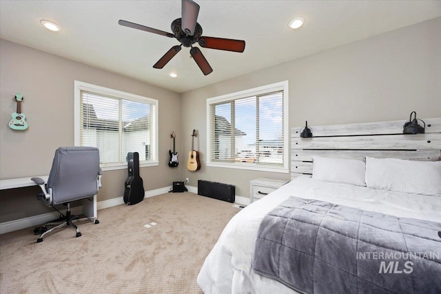 bedroom featuring light colored carpet and ceiling fan