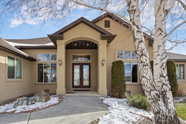 view of snow covered property entrance