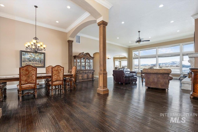 dining room featuring ornamental molding, dark wood-type flooring, ornate columns, and ceiling fan