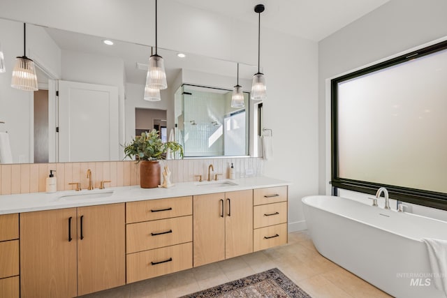 bathroom featuring vanity, decorative backsplash, and tile patterned floors