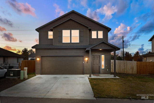 front of property featuring a lawn and a garage