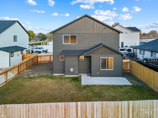 back of house featuring a yard and a patio area