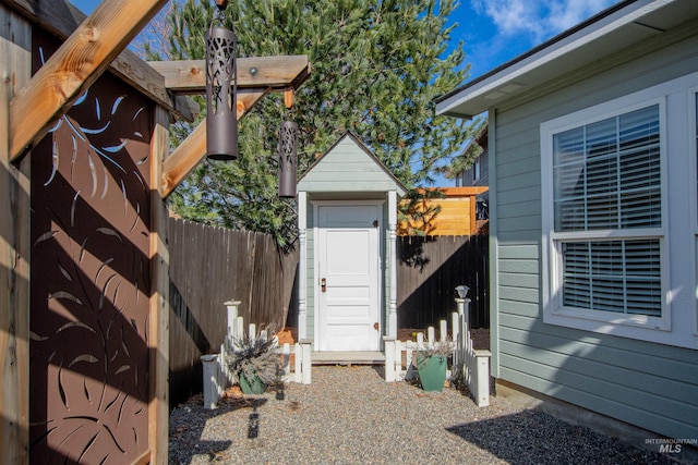 view of shed featuring fence