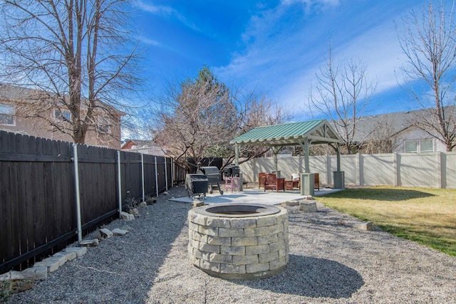 view of yard featuring a fire pit, a patio area, and a fenced backyard