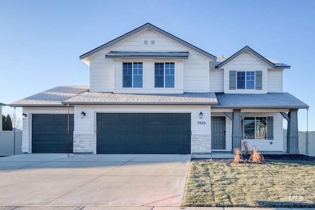 view of front of home with stone siding, roof with shingles, concrete driveway, and an attached garage