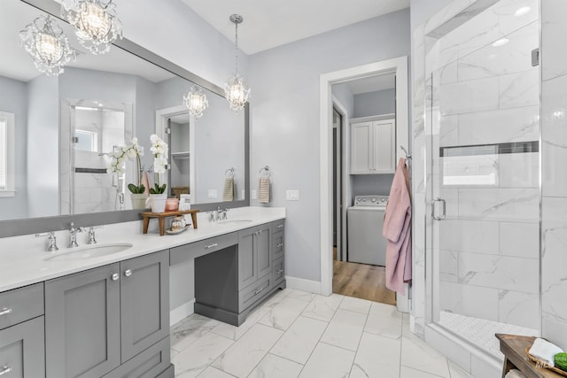 5001 S Twilight Mist Way, Meridian, ID 83642 - full bathroom with washer / dryer, a chandelier, double vanity, and a marble finish shower