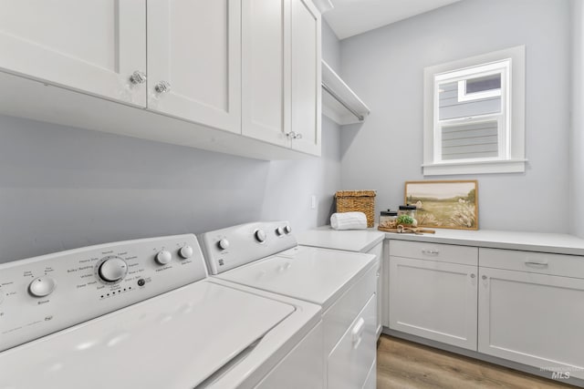 5001 S Twilight Mist Way, Meridian, ID 83642 - laundry area featuring washing machine and clothes dryer, cabinet space, and light wood-type flooring
