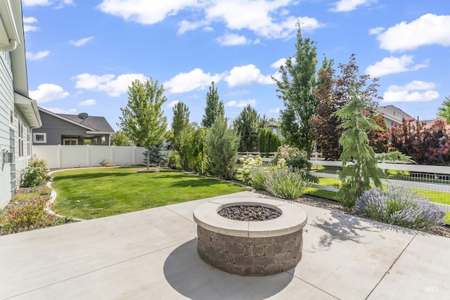 5001 S Twilight Mist Way, Meridian, ID 83642 - fenced backyard featuring a patio area and an outdoor fire pit