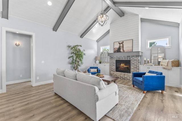 5001 S Twilight Mist Way, Meridian, ID 83642 - living area with a brick fireplace, light wood-style flooring, a chandelier, and recessed lighting