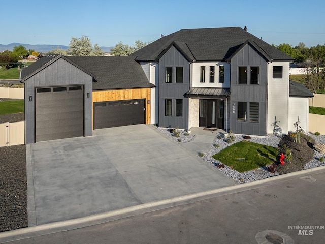 1590 N Watershed Ln, Star, ID 83669 - modern inspired farmhouse with a standing seam roof, an attached garage, metal roof, driveway, and board and batten siding