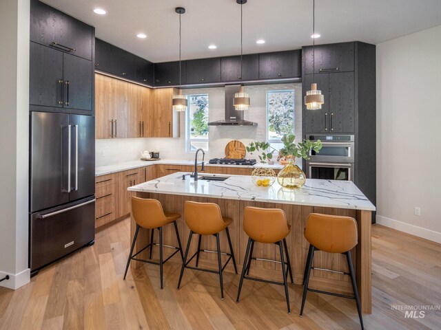 1590 N Watershed Ln, Star, ID 83669 - kitchen featuring appliances with stainless steel finishes, a sink, wall chimney exhaust hood, modern cabinets, and recessed lighting