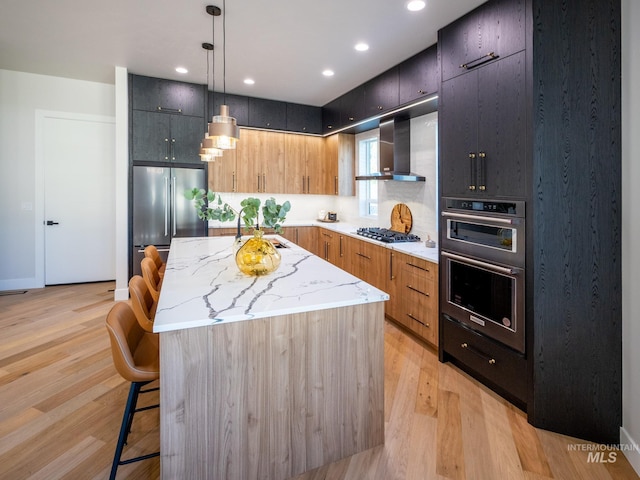 1590 N Watershed Ln, Star, ID 83669 - kitchen featuring wall chimney range hood, appliances with stainless steel finishes, a sink, modern cabinets, and a kitchen island