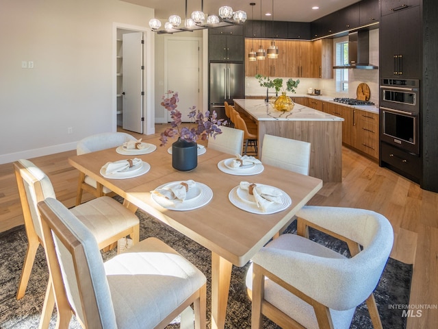 1590 N Watershed Ln, Star, ID 83669 - dining area with light wood-style flooring, a chandelier, and baseboards