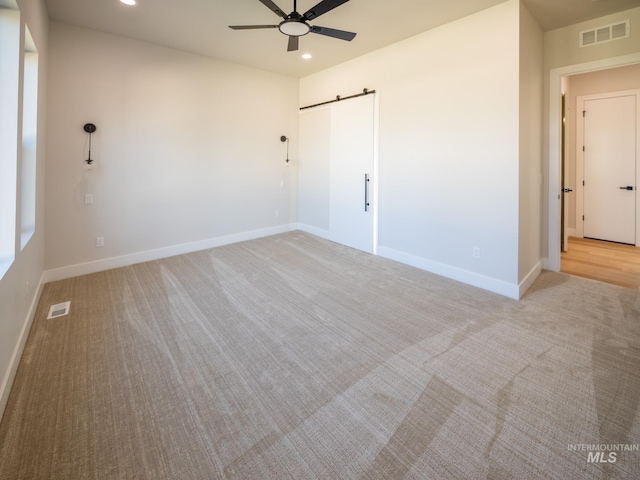 1590 N Watershed Ln, Star, ID 83669 - unfurnished bedroom featuring a barn door, recessed lighting, light carpet, and baseboards