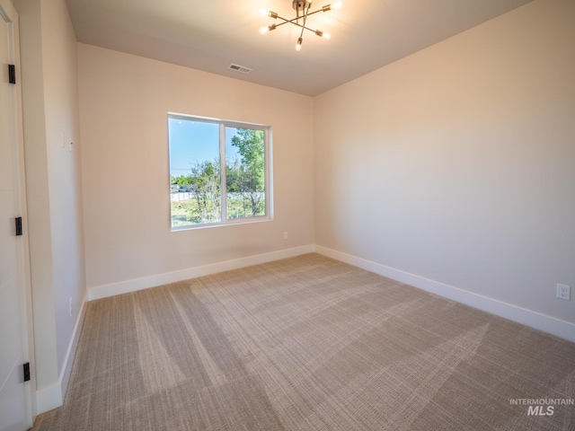 1590 N Watershed Ln, Star, ID 83669 - spare room featuring light carpet, baseboards, and a chandelier