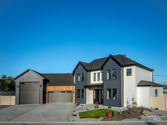1590 N Watershed Ln, Star, ID 83669 - modern farmhouse featuring a garage, fence, driveway, board and batten siding, and roof with shingles
