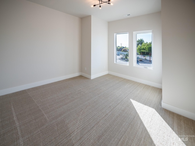 1590 N Watershed Ln, Star, ID 83669 - empty room featuring light carpet, a chandelier, and baseboards