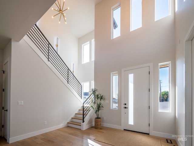 1590 N Watershed Ln, Star, ID 83669 - foyer with a high ceiling, stairs, light wood-style flooring, baseboards, and a chandelier