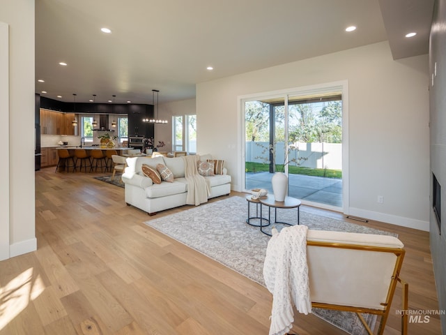 1590 N Watershed Ln, Star, ID 83669 - living room featuring recessed lighting, light wood-style flooring, and baseboards