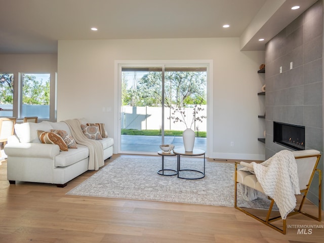 1590 N Watershed Ln, Star, ID 83669 - living area with recessed lighting, wood finished floors, a tiled fireplace, and baseboards