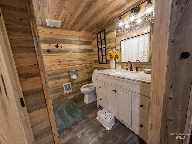 2263 Kilborn Ln, Mesa, ID 83632 - full bath featuring vanity, wooden ceiling, wood walls, toilet, and wood finished floors