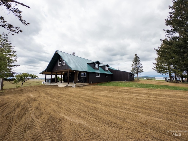 2263 Kilborn Ln, Mesa, ID 83632 - back of house featuring a porch, a lawn, and metal roof