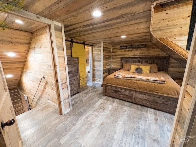 2263 Kilborn Ln, Mesa, ID 83632 - bedroom with wooden walls, wooden ceiling, a barn door, wood finished floors, and lofted ceiling