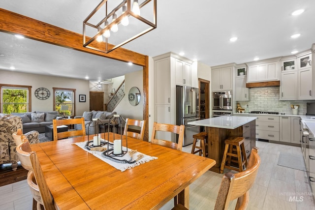 dining room with stairs and recessed lighting