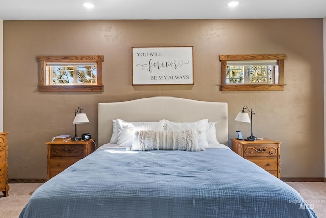 carpeted bedroom featuring baseboards and recessed lighting