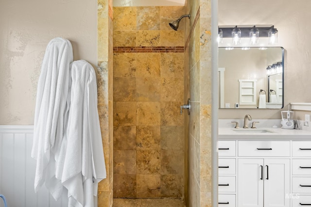 bathroom featuring walk in shower and vanity