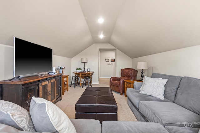 living area featuring light colored carpet and vaulted ceiling