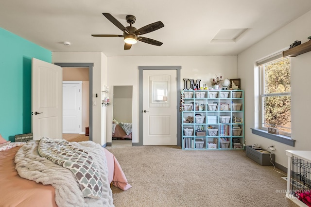 carpeted bedroom with ceiling fan and baseboards