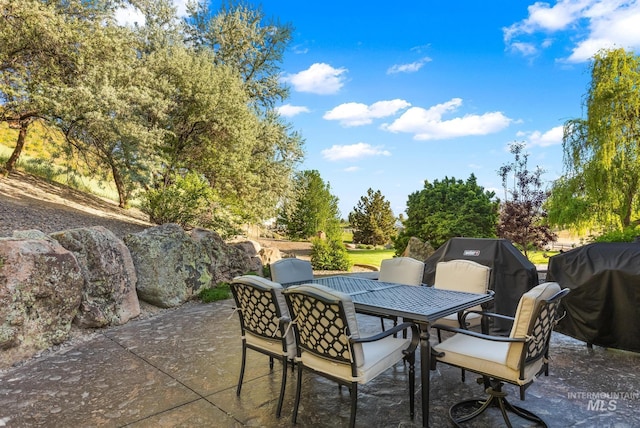 view of patio with outdoor dining space and area for grilling